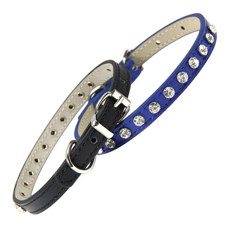 Two pet collars, one black and one blue with rhinestones, on a white background.