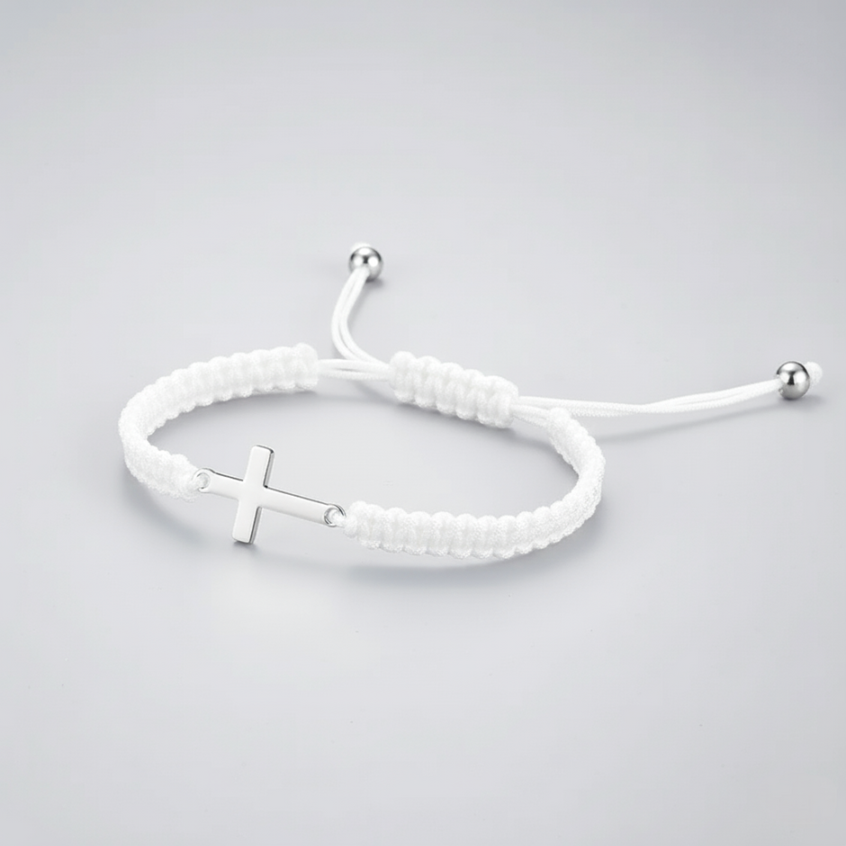 White braided bracelet with a silver cross charm on a light gray background