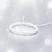 White braided bracelet on a light gray background with snowflake textures