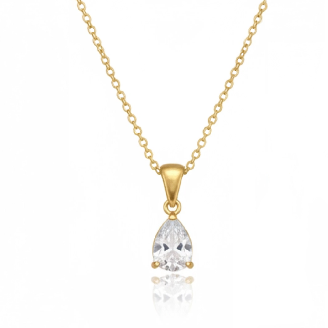 Gold necklace with a clear teardrop pendant on a white background