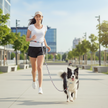 Woman running with a dog on a leash in an urban park setting