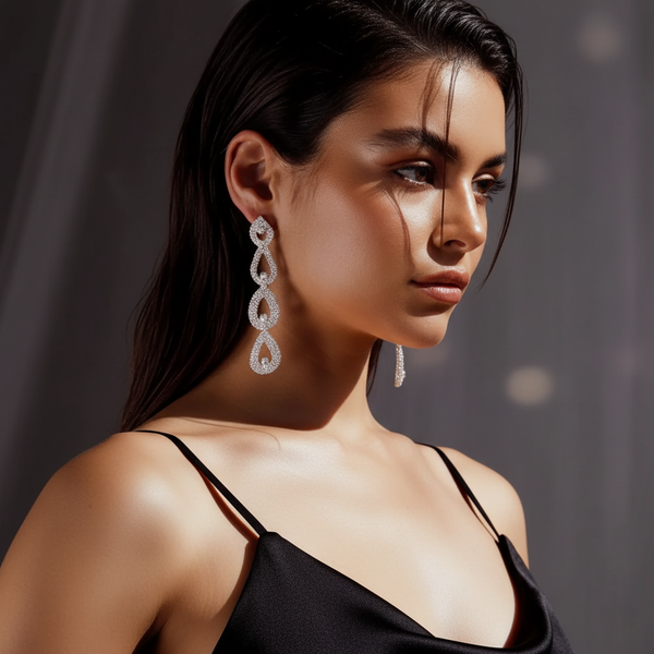 A woman wearing elegant earrings with a dark background