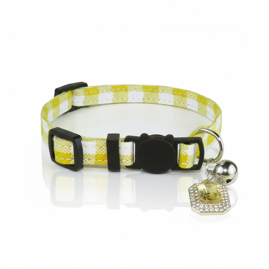 Yellow and white checkered dog collar with a black buckle and silver bell on a white background