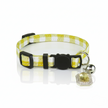 Yellow and white checkered dog collar with a black buckle and silver bell on a white background