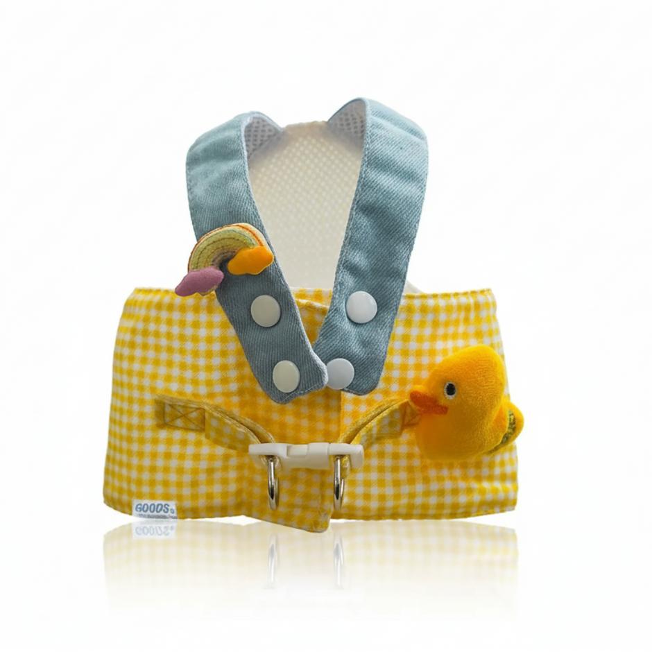 Yellow checkered baby carrier with gray hood and duck toy on a white background