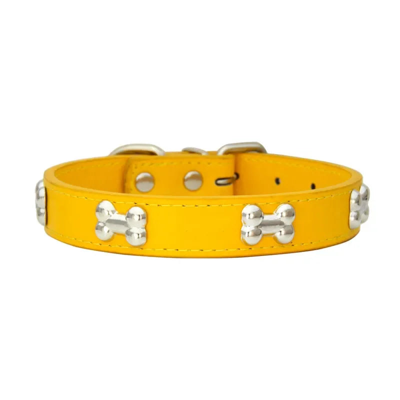 Yellow dog collar with silver bone-shaped studs on a white background