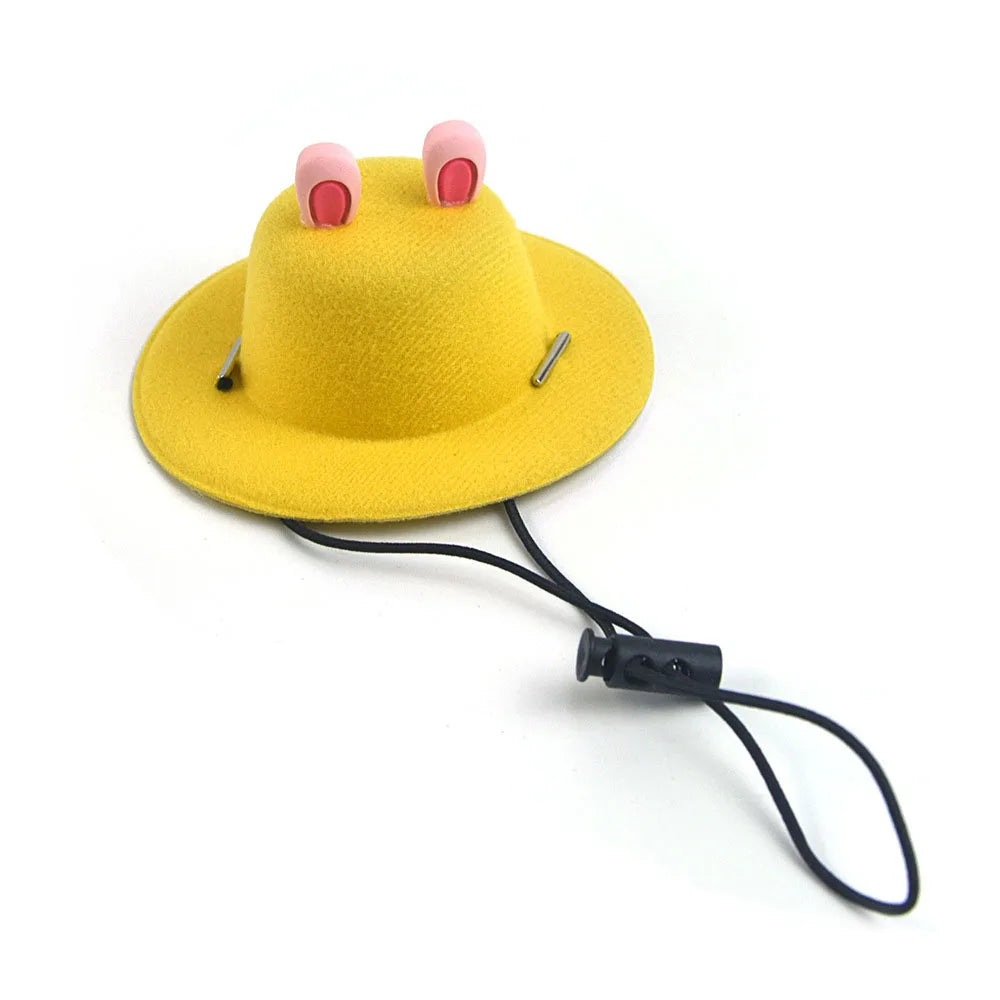 Yellow pet hat with pink ears and a black strap on a white background