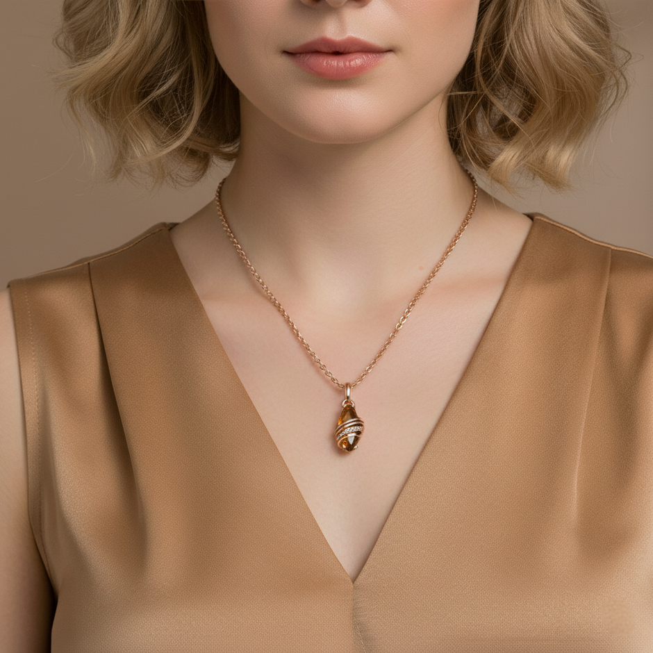 Woman wearing a gold necklace with a pendant against a neutral background