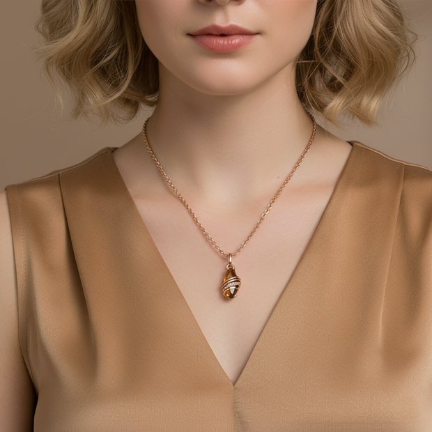 Woman wearing a gold necklace with a pendant against a neutral background