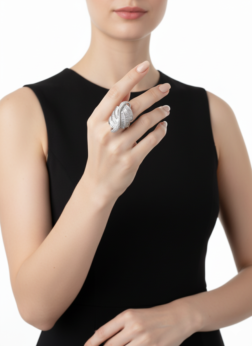 A woman wearing a silver ring on her finger against a white background