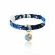 Navy blue patterned cat collar with a gold and blue spherical charm on a white background