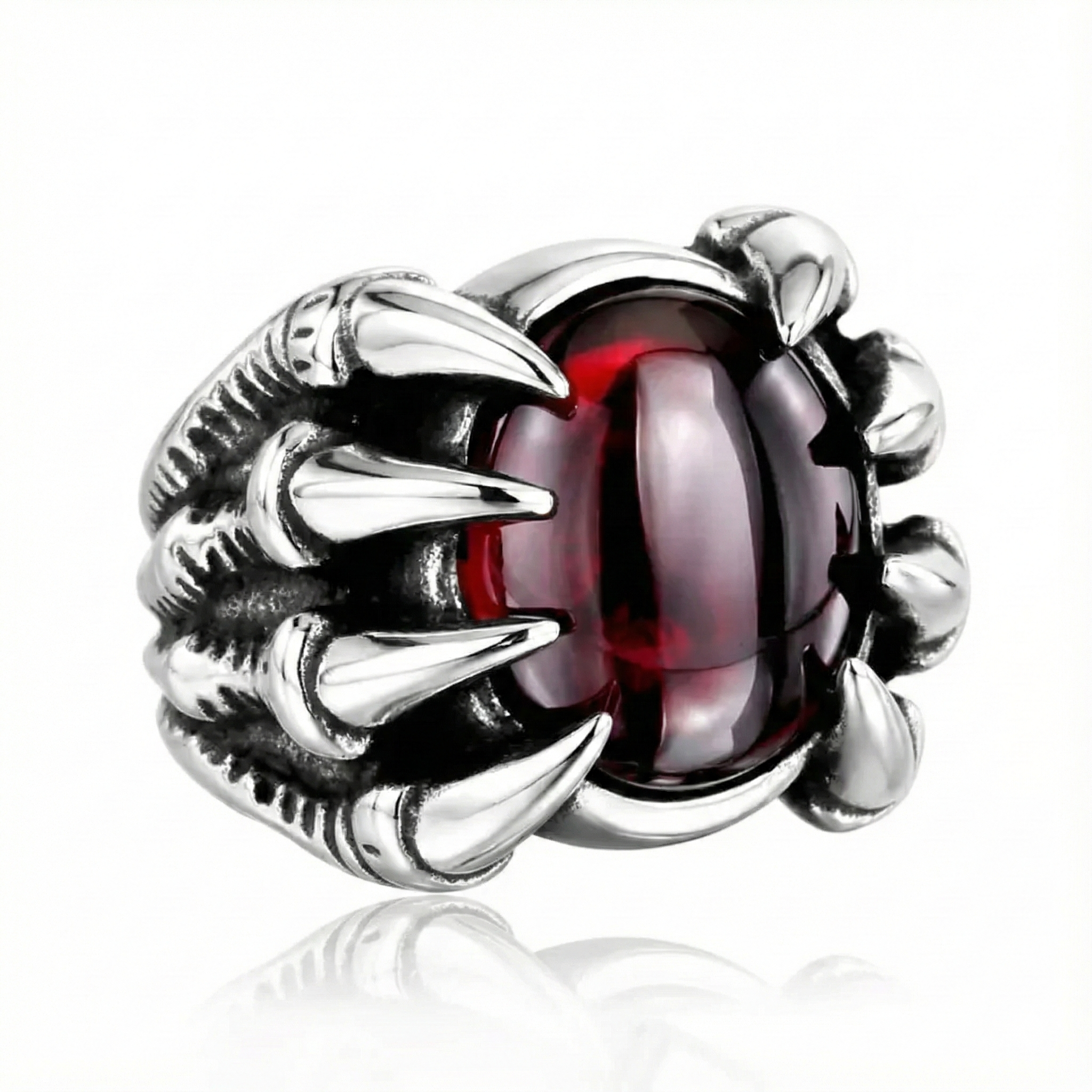 silver ring with a red gemstone on a white background