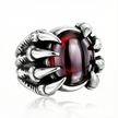 silver ring with a red gemstone on a white background