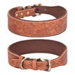 Two brown leather dog collars with floral embossing on a white background