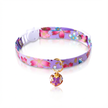 Purple floral-patterned cat collar with a bell on a white background