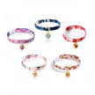 Set of colorful floral-patterned cat collars with small charms on a white background