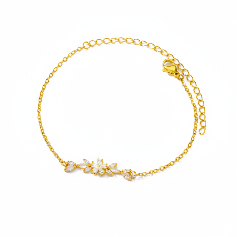 Gold bracelet with floral design on a white background