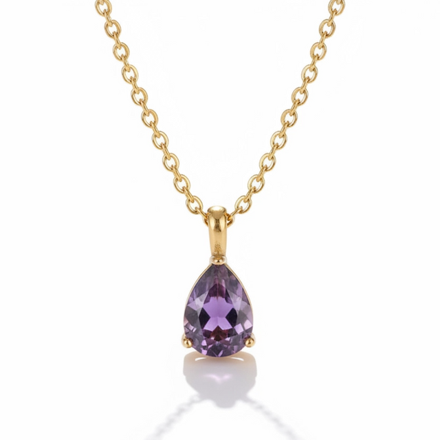 Gold necklace with a purple teardrop-shaped gemstone on a white background