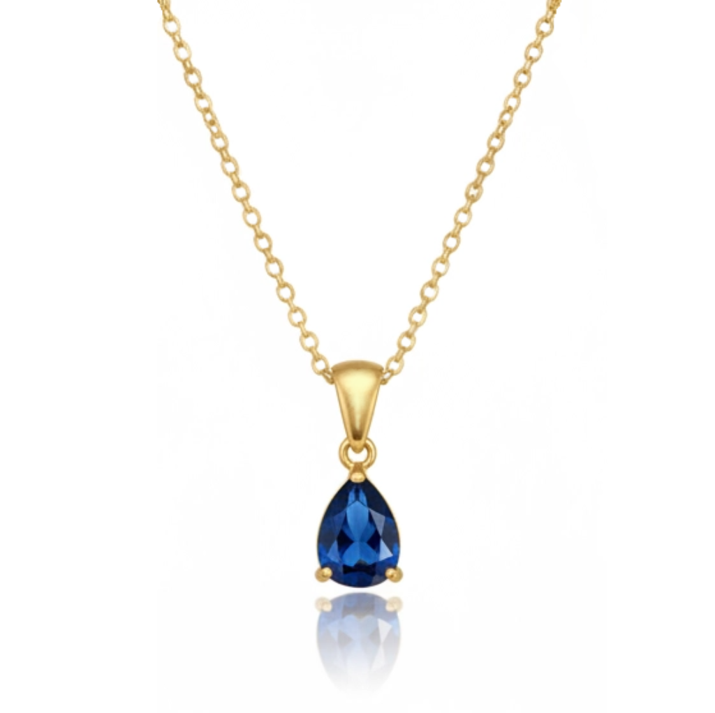 Gold necklace with a blue teardrop pendant on a white background