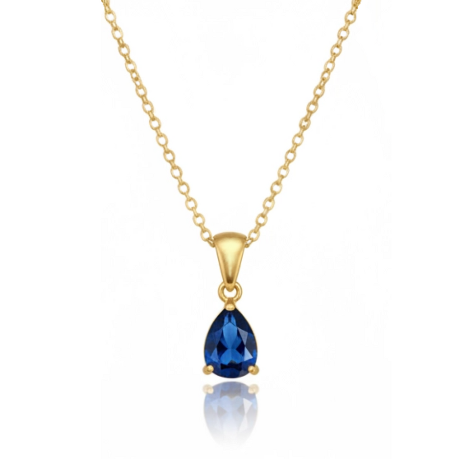 Gold necklace with a blue teardrop pendant on a white background