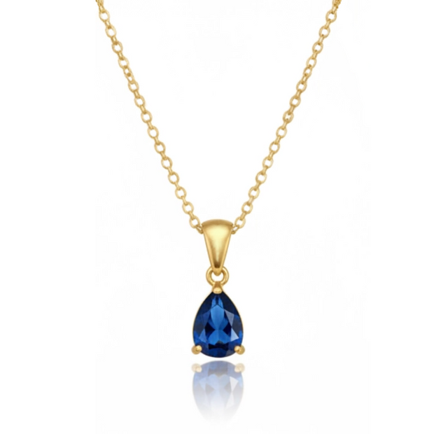 Gold necklace with a blue teardrop pendant on a white background