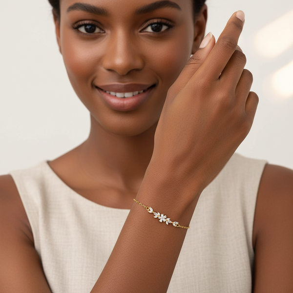 Woman wearing a gold bracelet with a neutral background