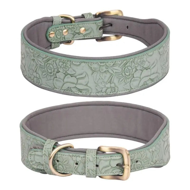 Two green leather dog collars with floral embossing on a white background.