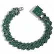 Green braided bracelet with silver accents on a white background