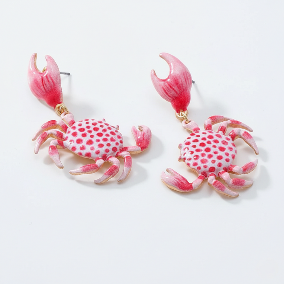 Pink crab-shaped earrings on a white background