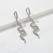 Silver snake-shaped earrings on a white background
