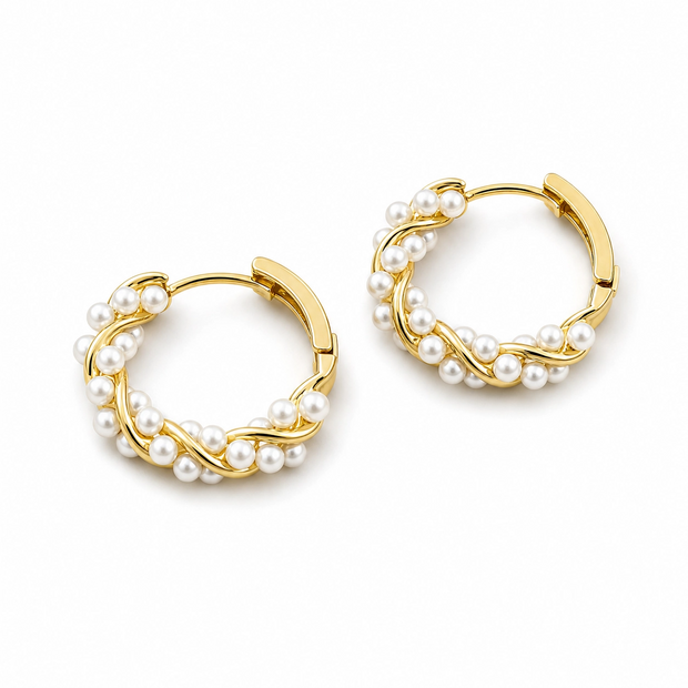 Gold hoop earrings with pearl accents on a white background