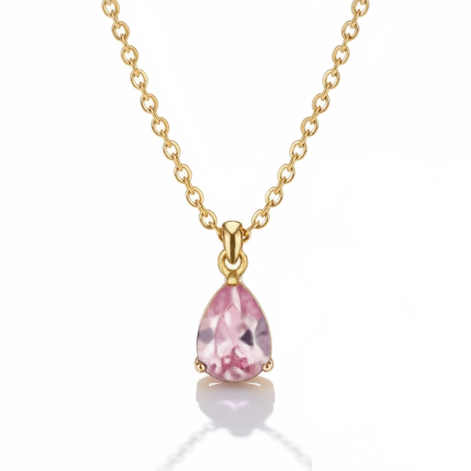 Gold necklace with a pink teardrop pendant on a white background