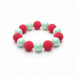 Bracelet with pink and green beads on a white background