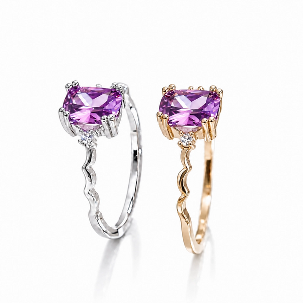Two rings with purple gemstones on a white background