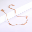Rose gold anklet on a white background