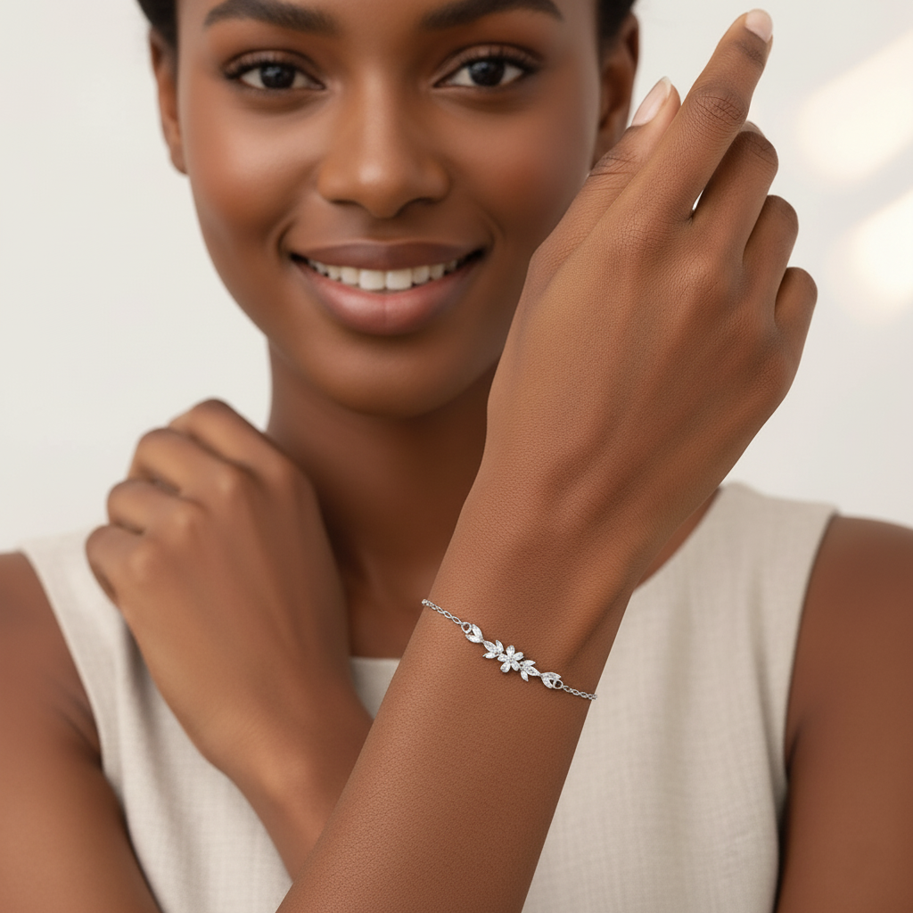 Woman wearing a silver bracelet on her wrist with a plain background