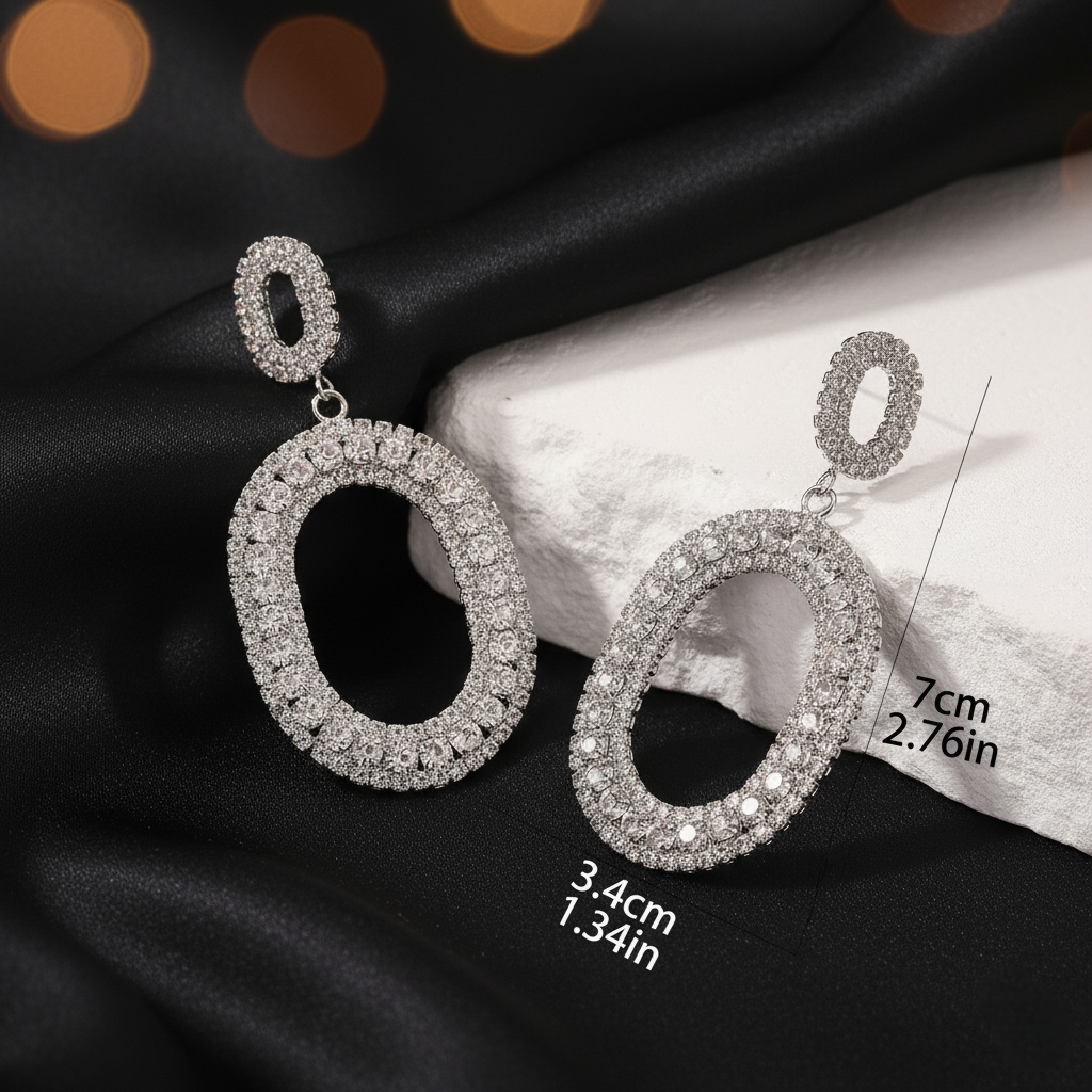 Silver hoop earrings on a black fabric background with measurements indicated.