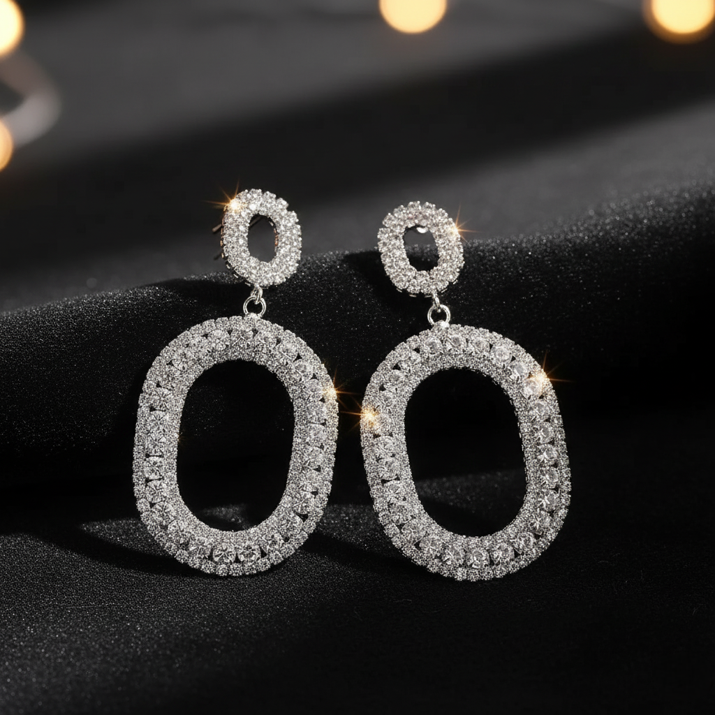 Pair of silver hoop earrings on a black background