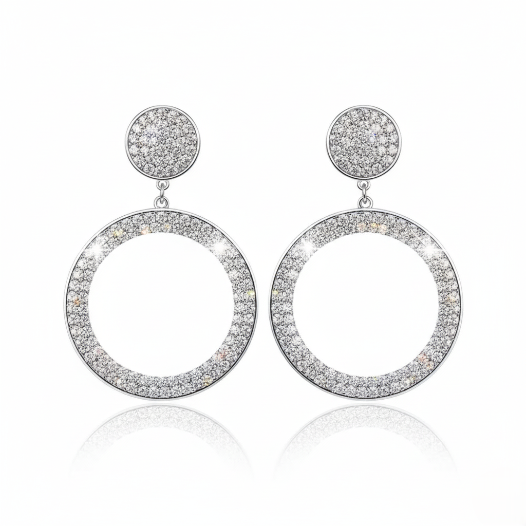 Pair of silver hoop earrings with circular designs on a white background