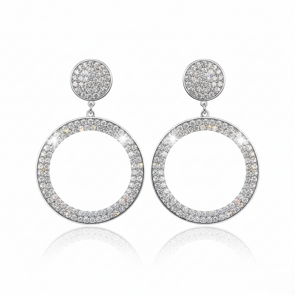 Pair of silver hoop earrings with circular designs on a white background