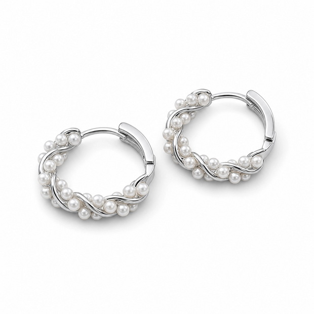 Pair of silver hoop earrings with pearls on a white background
