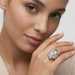 Close-up of a woman's hand wearing a silver ring with a white background