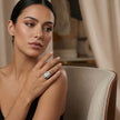 Woman wearing a diamond ring in an elegant indoor setting