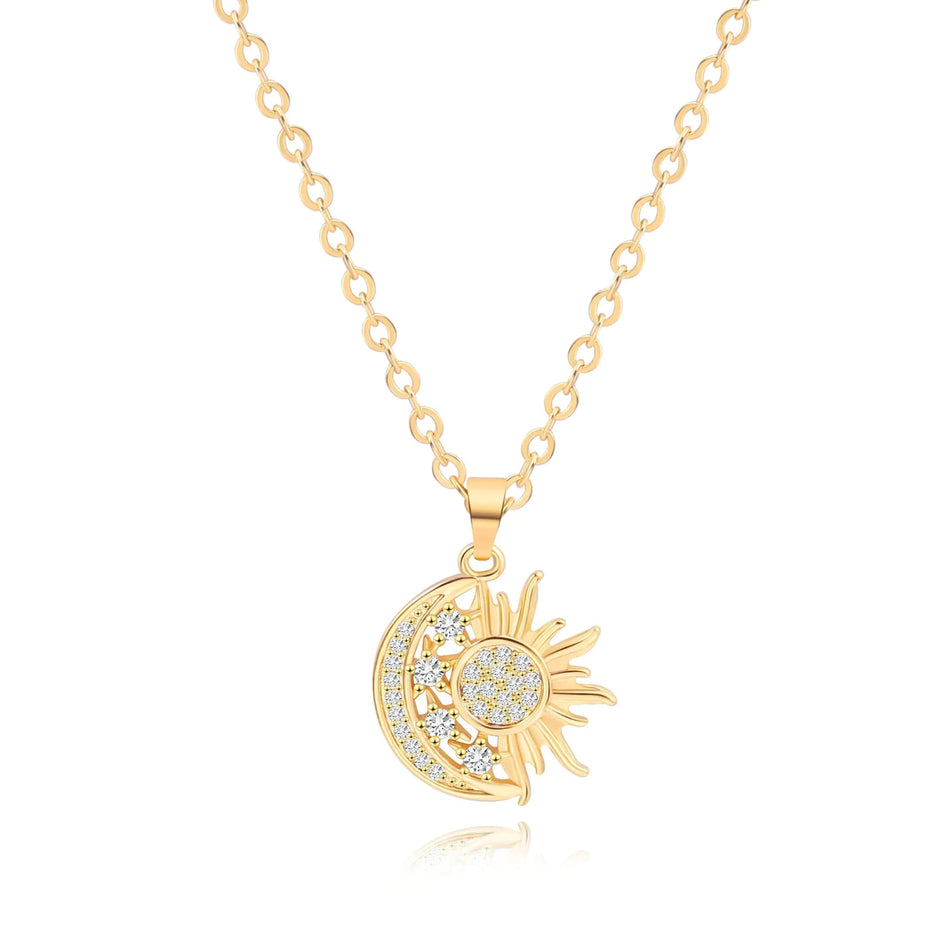 Gold necklace with sun and moon pendant on a white background