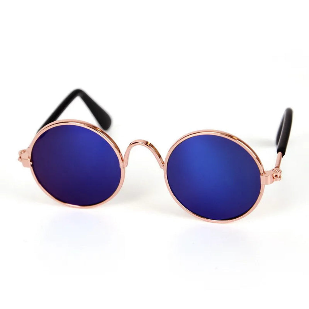 Round sunglasses with blue lenses and rose gold frame on a white background