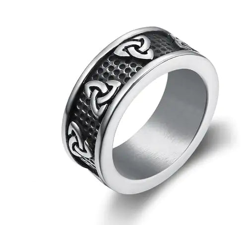 Silver trinity knot ring, Celtic wedding band with intricate designs on a white background