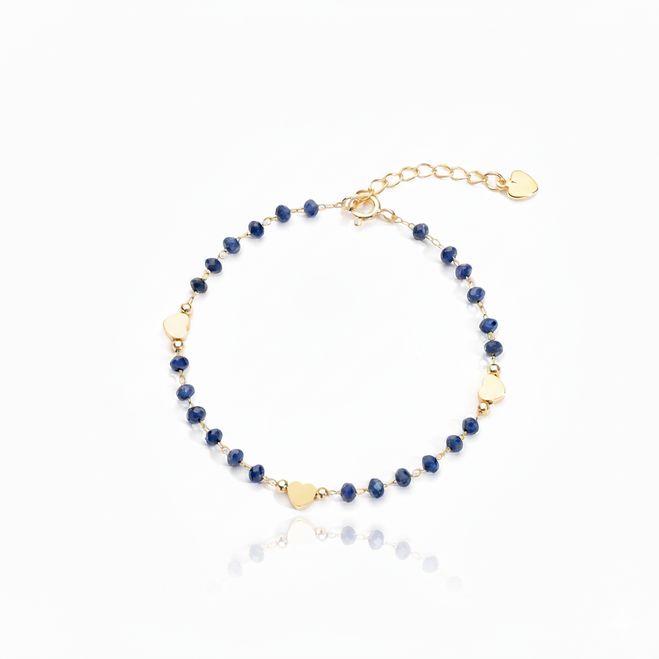 Gold and blue beaded bracelet on a white background