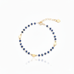 Gold and blue beaded bracelet on a white background