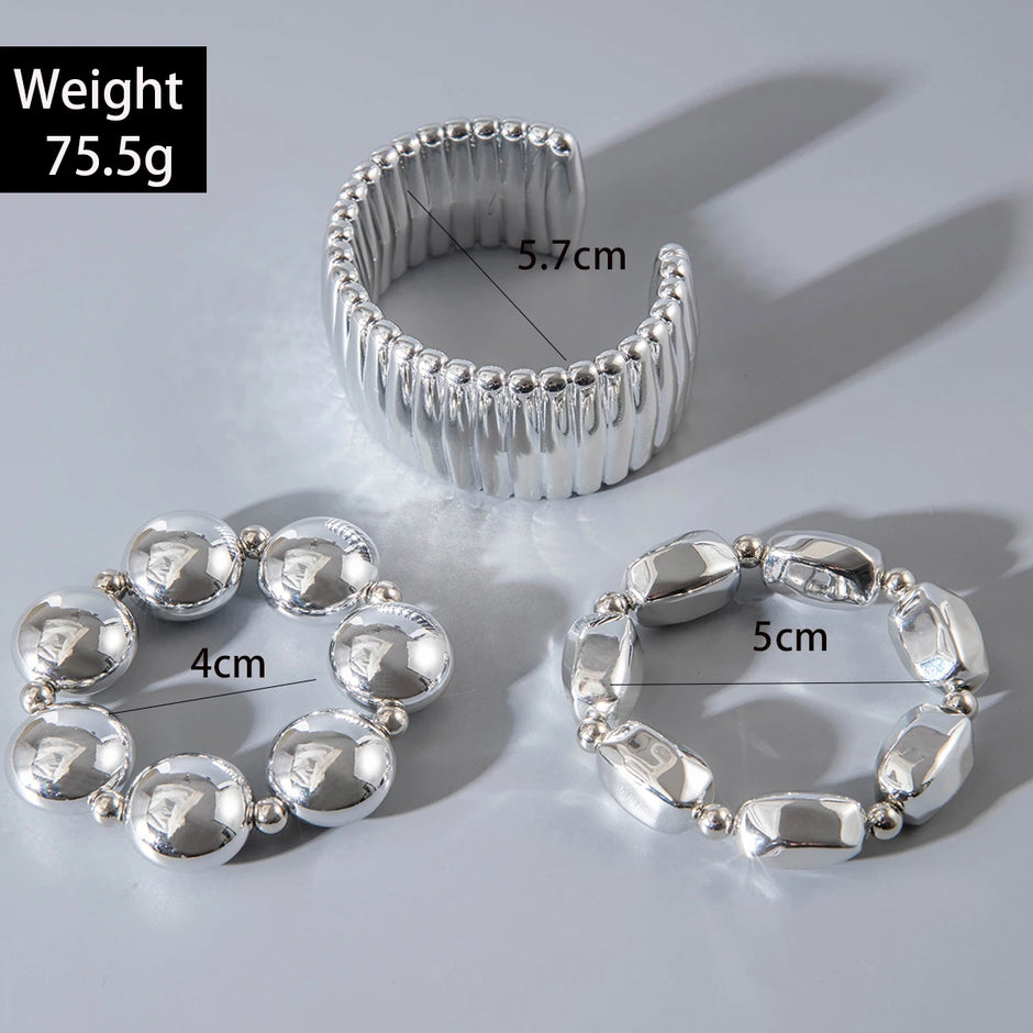 Silver bangle with measurements on a light gray background